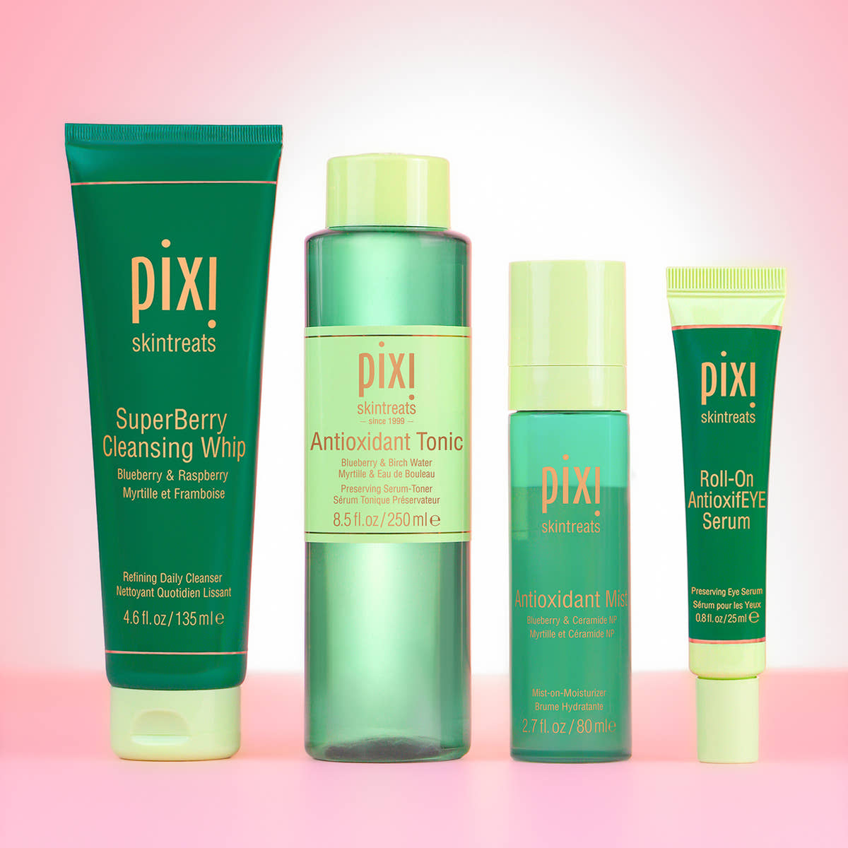 SuperBerry Cleansing Whip, Antioxidant Tonic, Antioxidant Mist and Roll-On AntioxifEYE Serum on pink background.