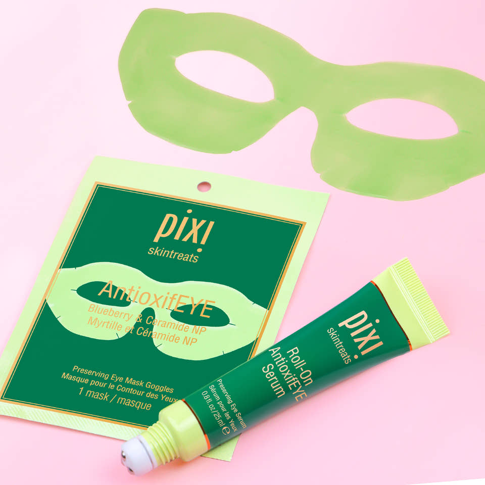 PIXI skincare products including AntioxifEYE Eye Mask Goggles and Roll-on AntioxifEYE serum on a pink background view 2
