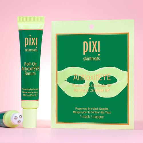 PIXI skintreats Roll-On AntioxidEYE Serum and AntioxidEYE Eye Mask Goggles on a pink background