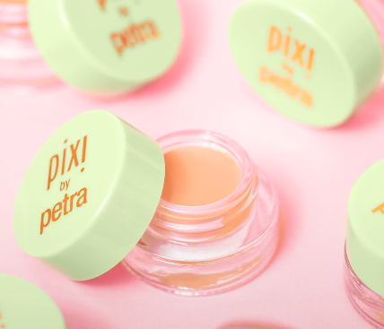 Pixi Correction Concentrate peach under-eye colour corrector in an open glass pot with green lid view 2