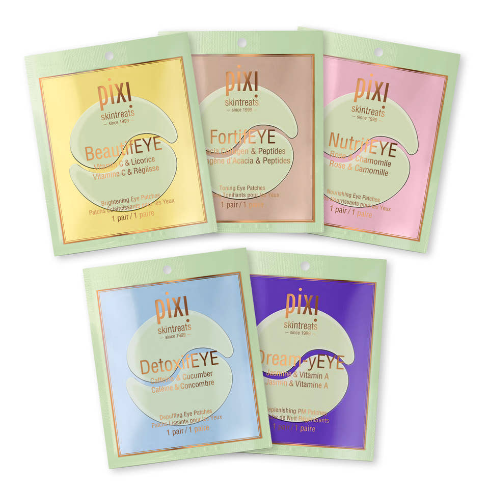 Pixi Skincare eye mask sachets arranged on a white background, including BeautyEYE, FortEYE, NutriEYE, DetoxEYE, and DreamEYE in pastel yellow, peach, pink, blue, and purple packaging. view 2
