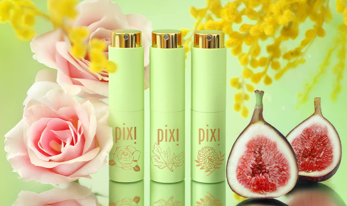 PixiPerfume trio on a green background surrounded by roses, figs, and mimosa branches