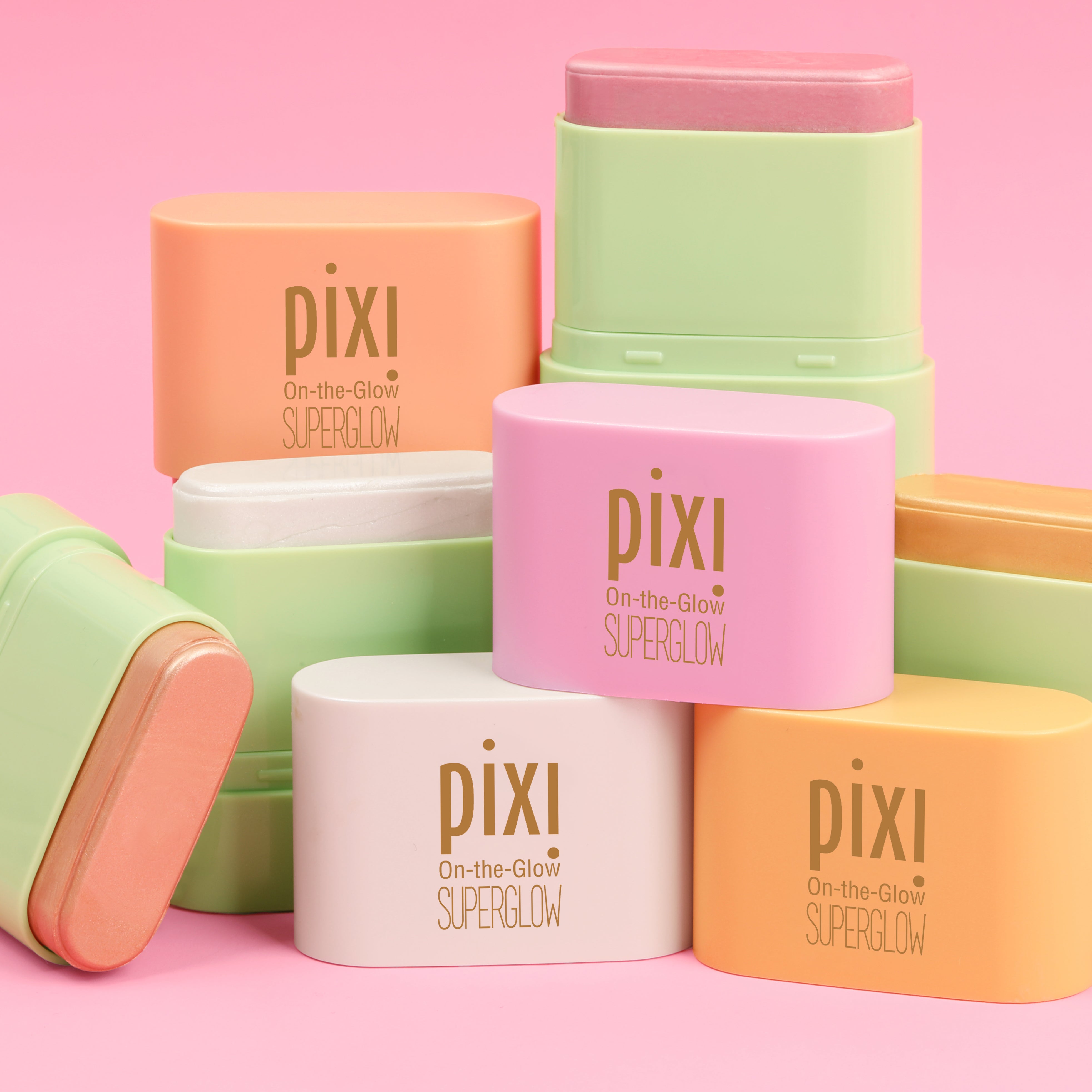 On-the-Glow SUPERGLOW Petites in 4 shades shown on a pink background