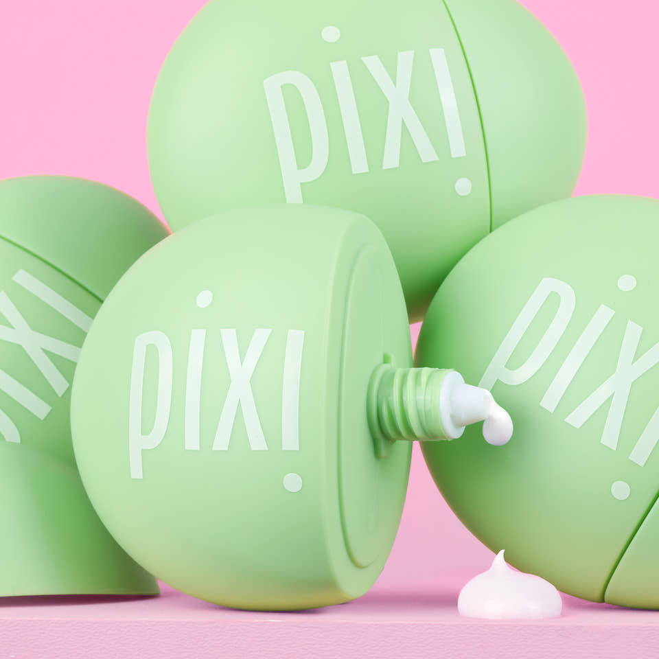 Green PIXI skincare product HandHero showing texture on a pink background view 1