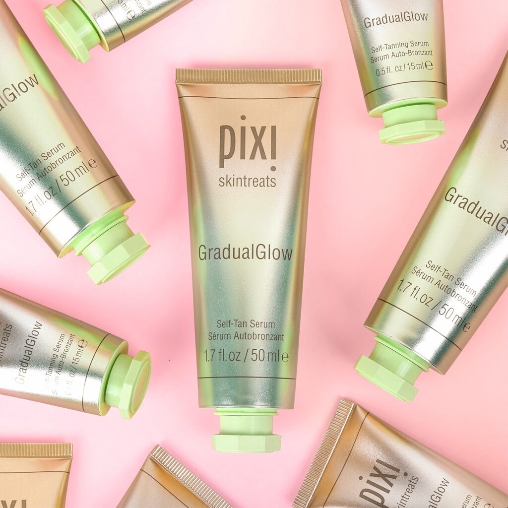 PIXI Gradual Glow skincare products on a pink background