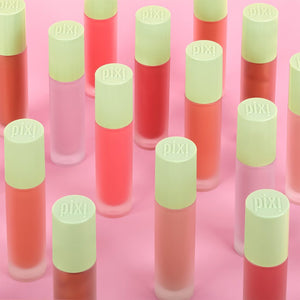 Pattern of PIXI LiquidGlow with green caps on a pink background