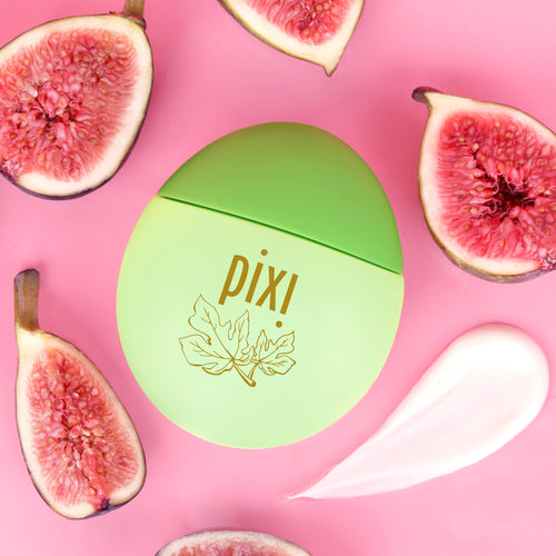 Pixi HandHero PixiFig scented hand lotion surrounded by fresh figs, including a swatch to show texture on a pink background. view 2