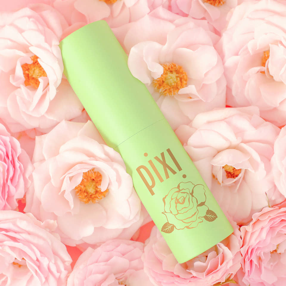PixiRose Perfume shown on a rose background view 1