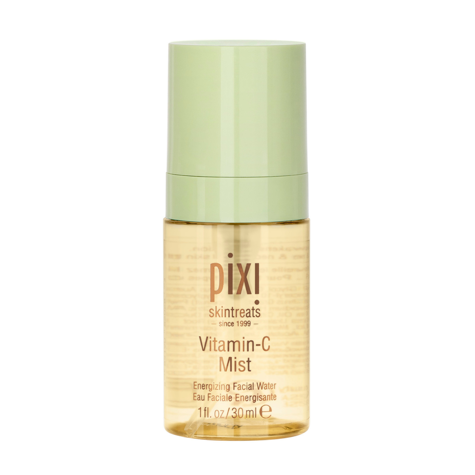 Pixi Skintreats Vitamin-C Mist facial mist in a clear bottle showing the golden liquid inside, with a light green cap, on a white background. view 1