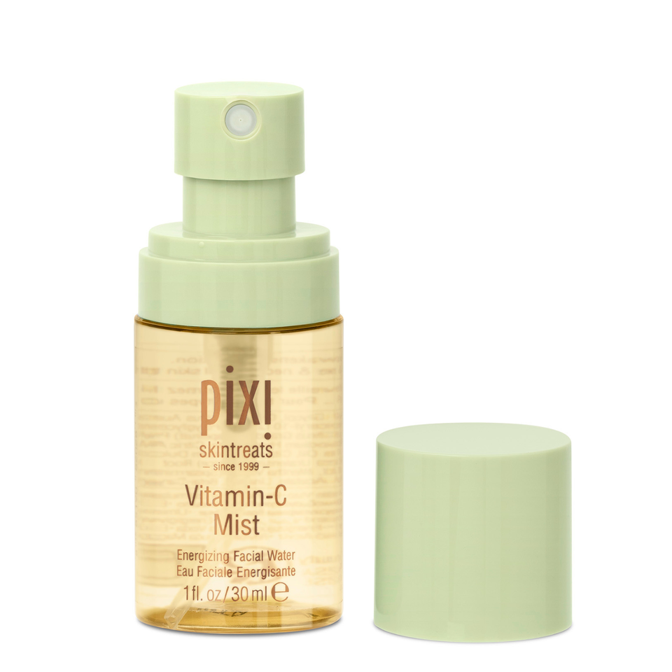 Pixi Skintreats Vitamin-C Mist facial spray bottle with a pale green pump and cap, shown next to its cap on a white background. view 2