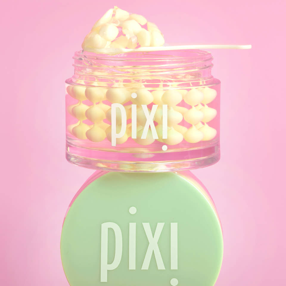 Pixi Vitamin-C CreamSerum product with pink lid and green cap on a pink background view 2